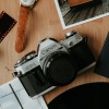 travel and photography accessories laid out on table